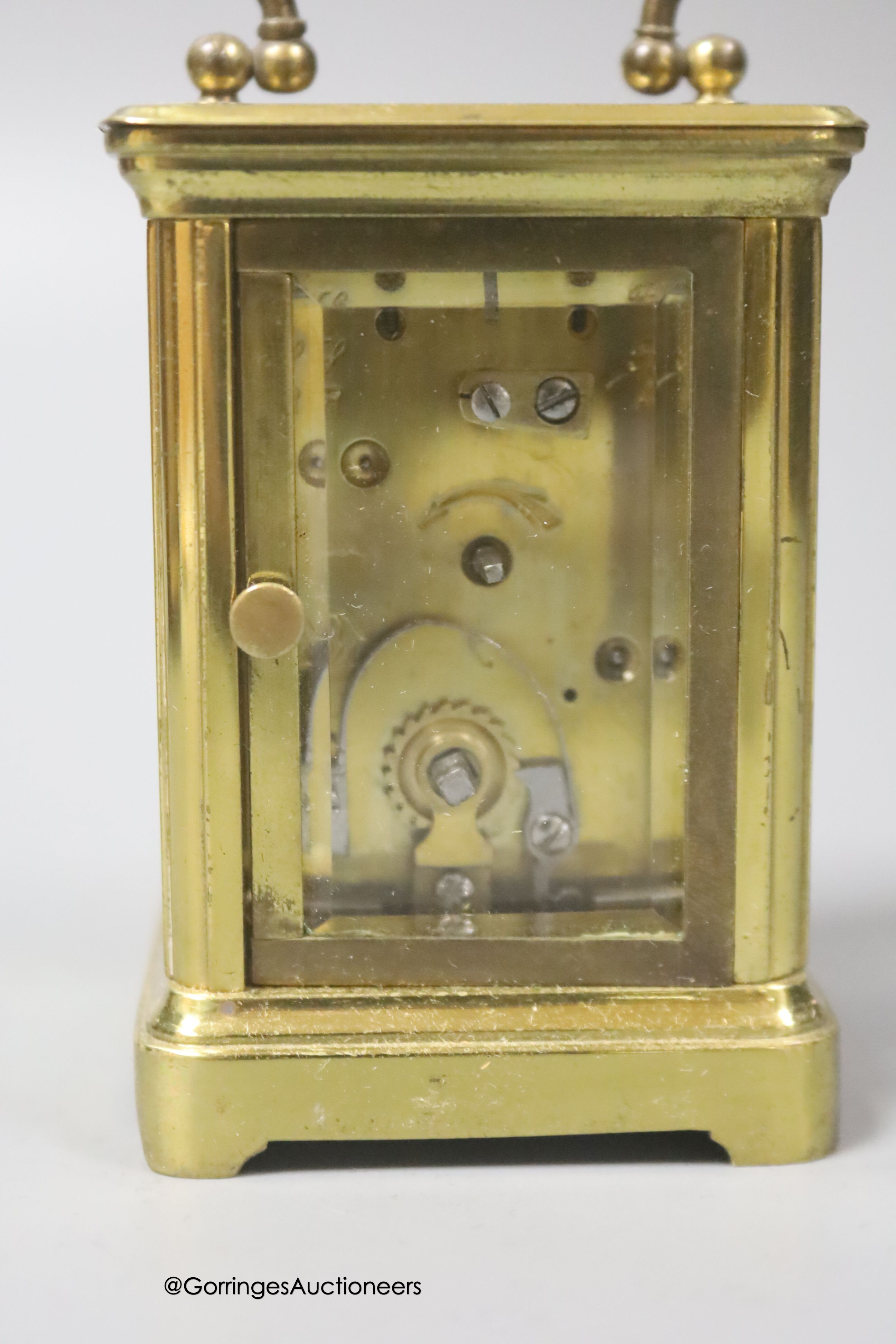 A brass cased carriage timepiece, 7.5cm, in a leather carrying case